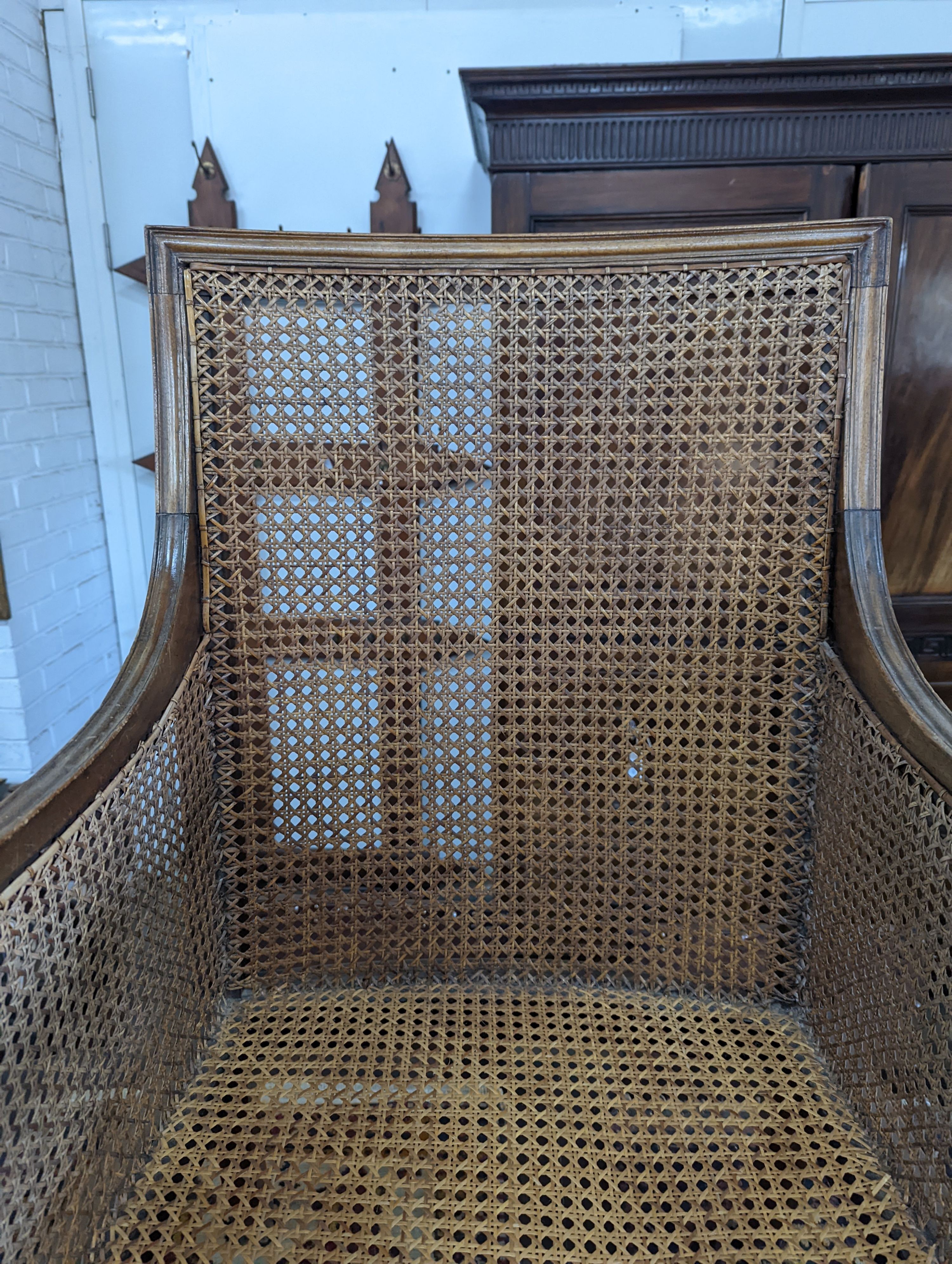 A Regency style mahogany bergere armchair, width 59cm, depth 56cm, height 97cm